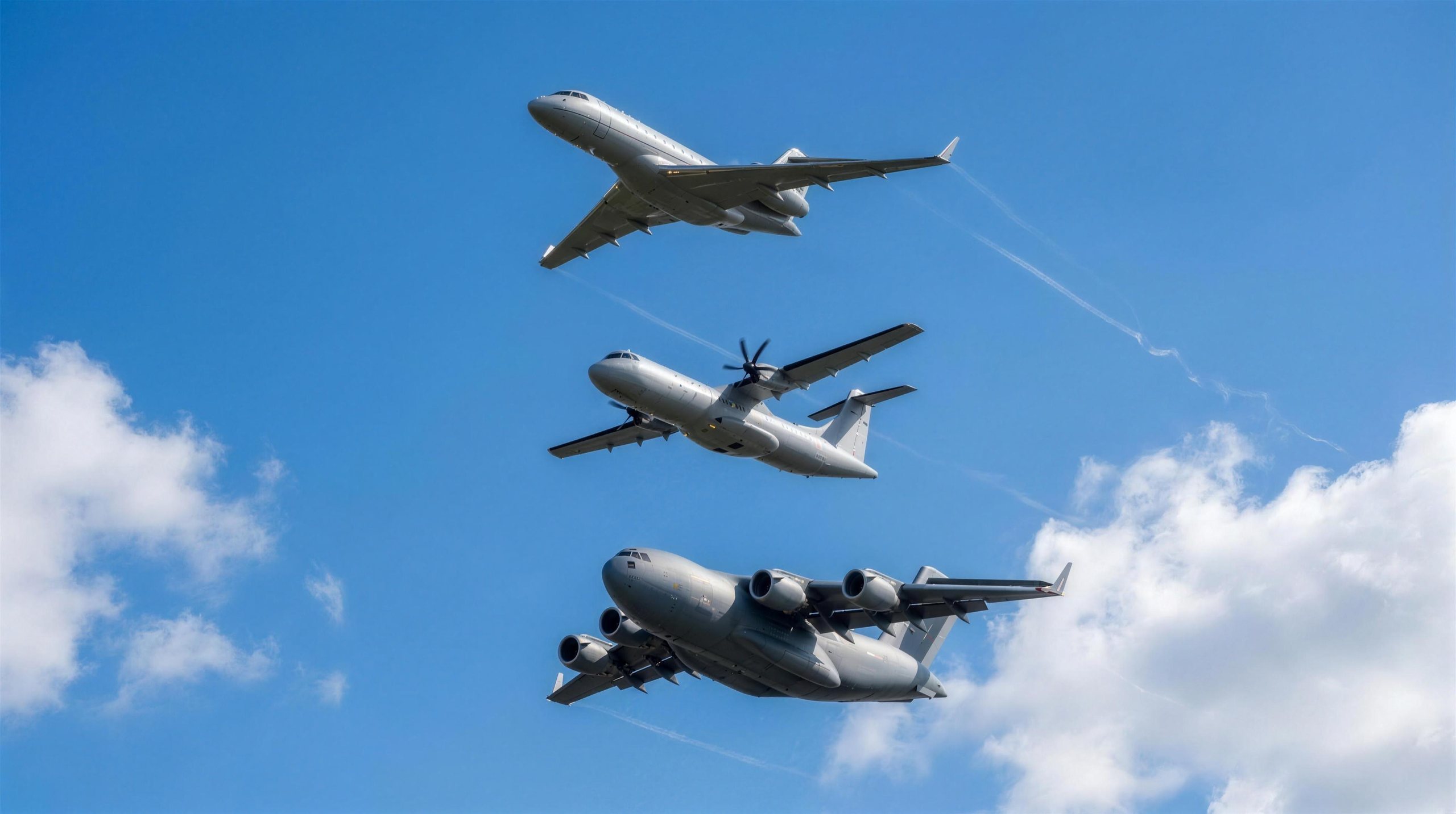 Three unmarked aircraft climbing in loose formation
